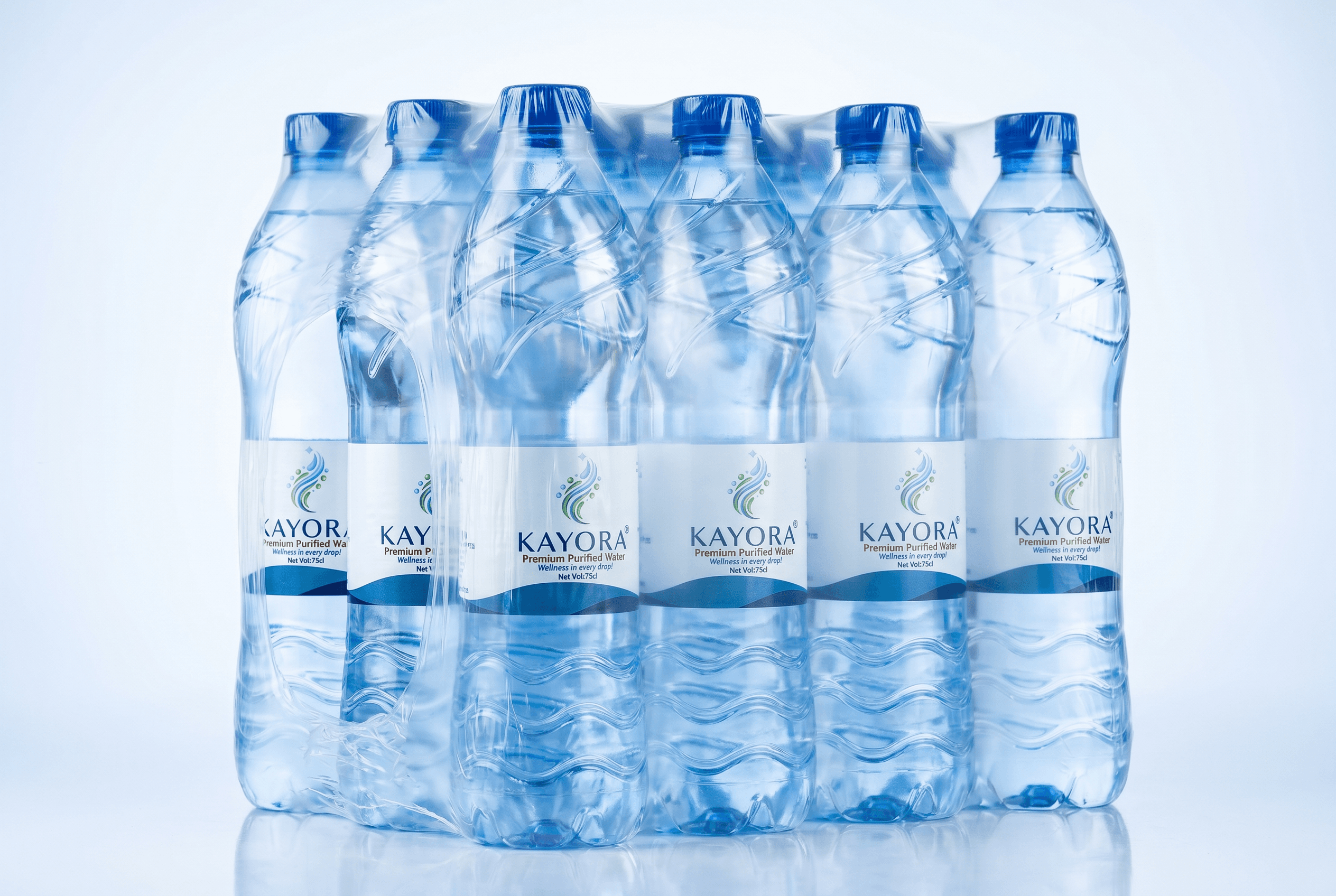 Kayora water cases palletised for distribution — 12 bottles per shrink-wrapped case